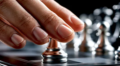 Hand Moving A Silver Chess Piece On A Board