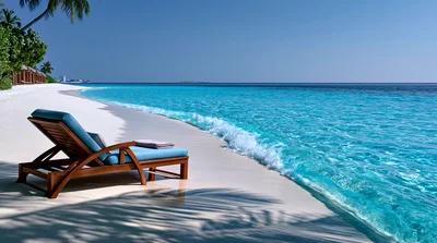 Wooden Lounge Chair On A Tropical White Sand Beach