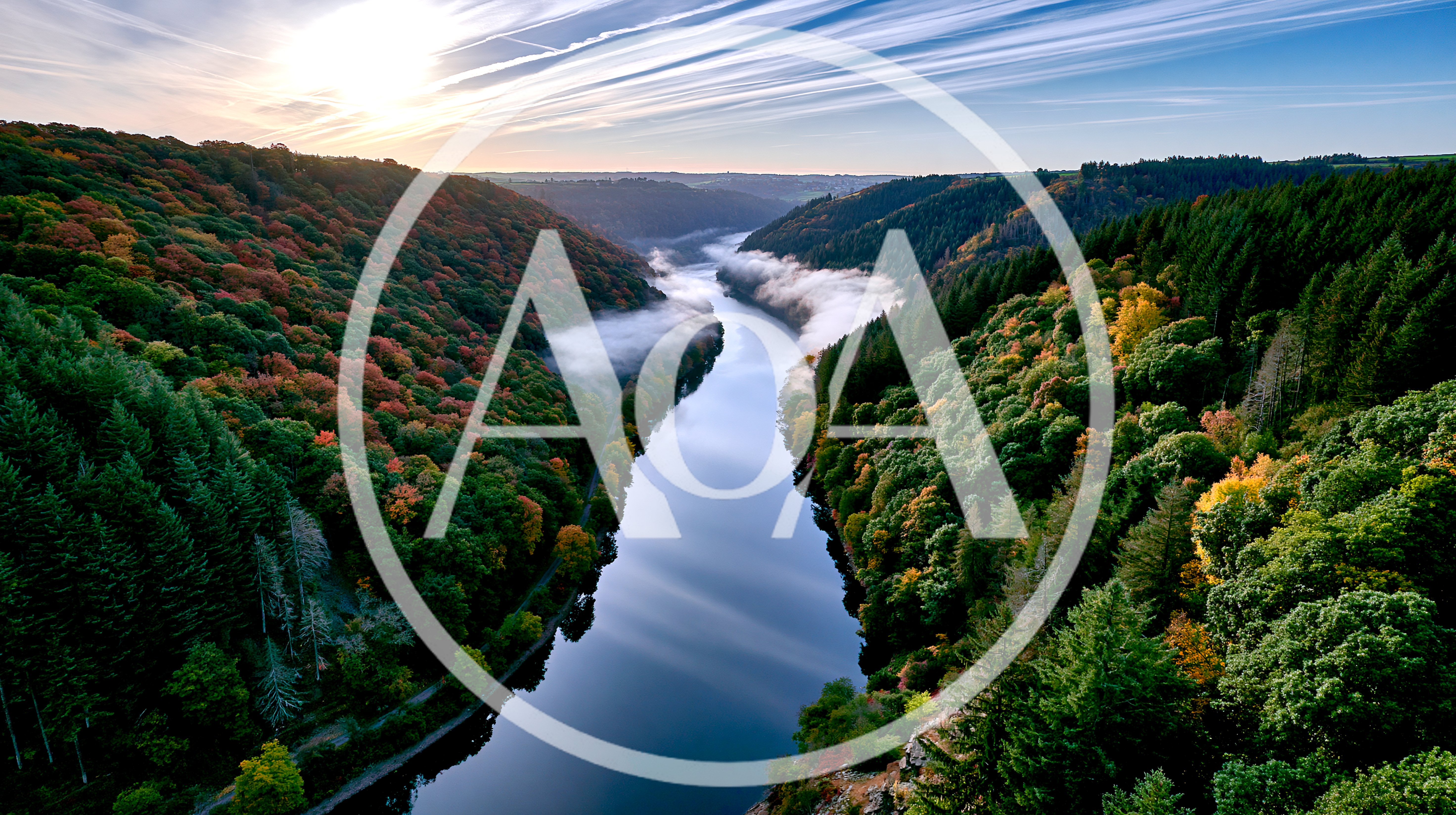 Aerial View Of A Winding River Through Autumn Forest