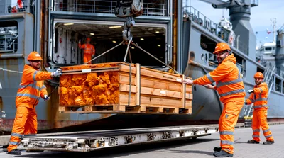 Dock Workers Loading Wooden Crate onto Ship
