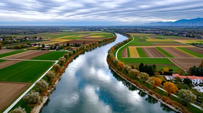 Aerial View Of A Winding River Through Agricultural Fields