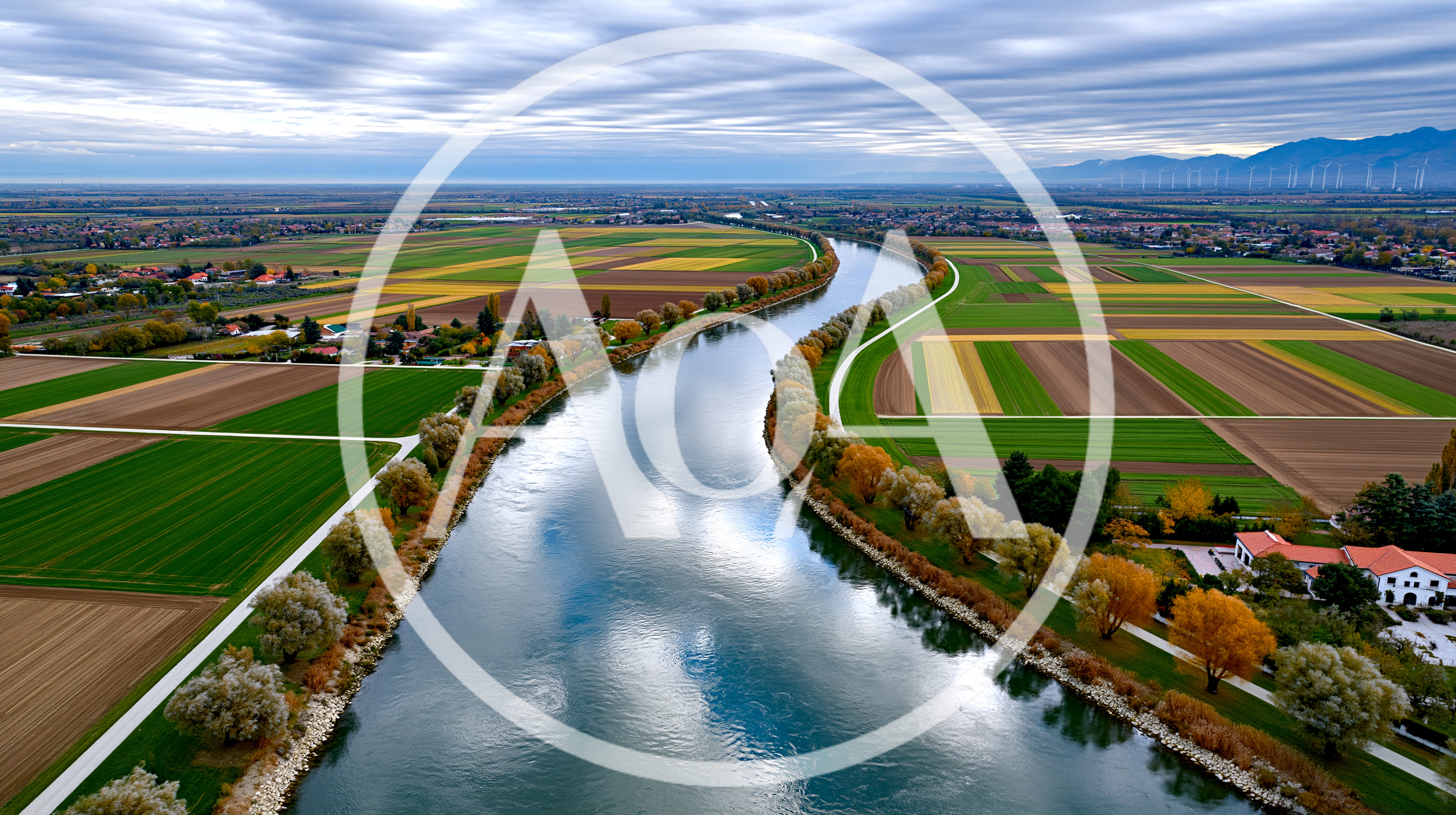Aerial View Of A Winding River Through Agricultural Fields