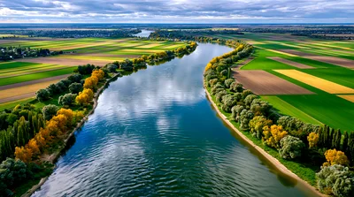 Aerial View Of A Winding River Through Agricultural Fields