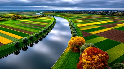 Aerial View Of A Winding River Through Agricultural Fields