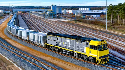 Freight Train Moving Through Industrial Rail Yard