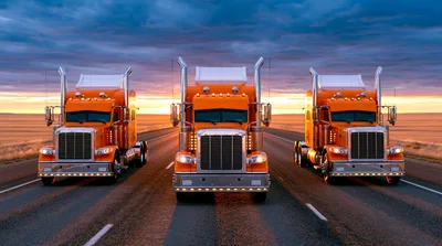 Three Orange Semi Trucks Driving On A Highway