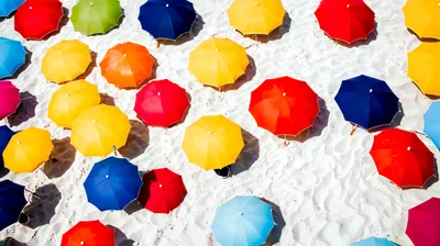 Aerial View Of Colorful Beach Umbrellas On White Sand
