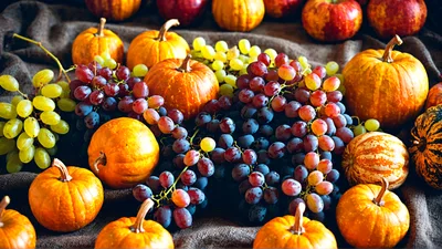 Autumn Harvest Display With Pumpkins And Grapes