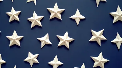 White Origami Stars On Dark Blue Background