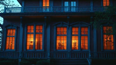 Exterior View Of A Historic Victorian Mansion At Night