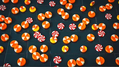 Assorted Orange And White Candies On Dark Surface