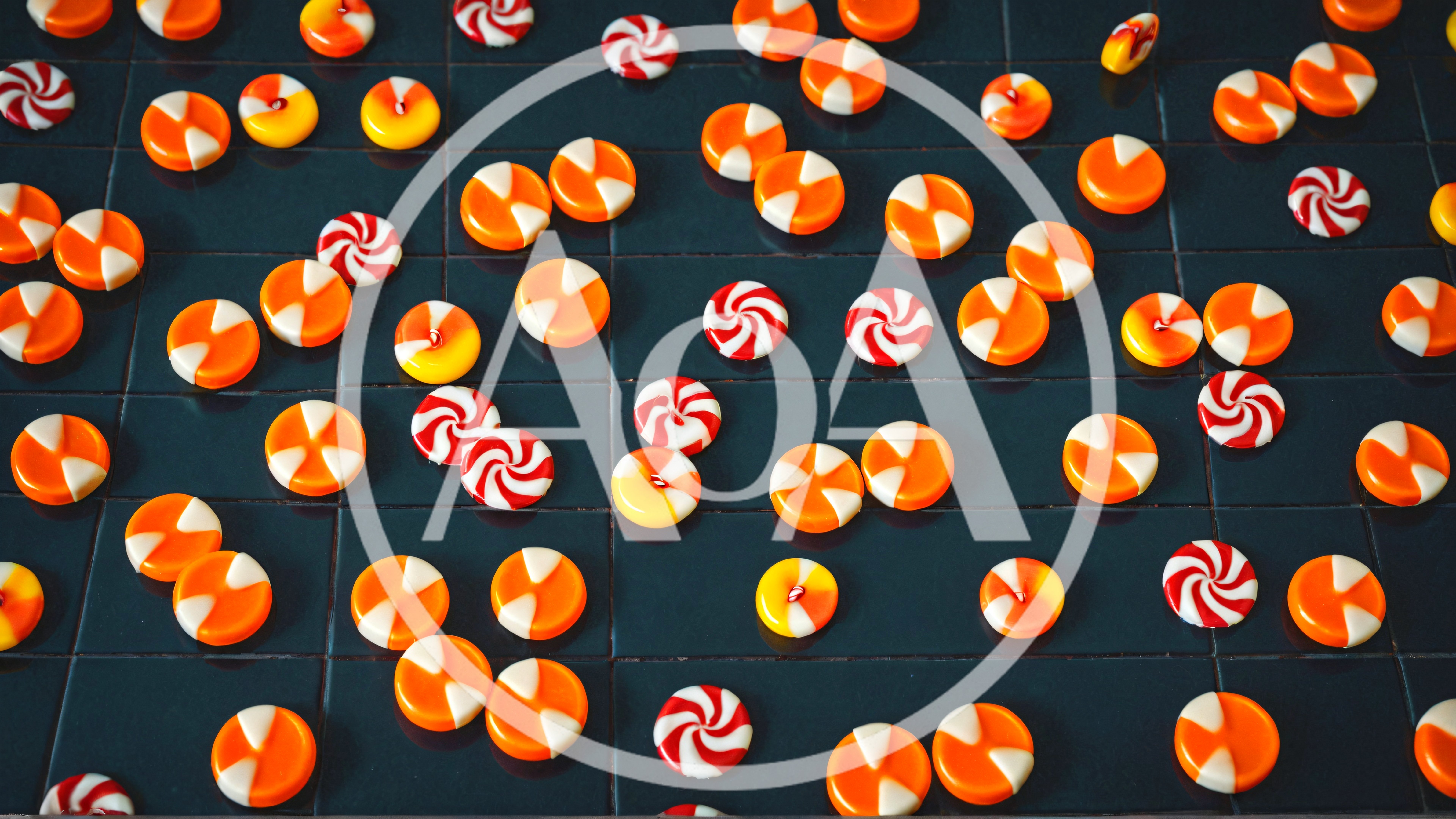 Assorted Orange And White Candies On Dark Surface