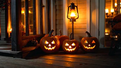 Glowing Jack O Lanterns On A Porch At Night