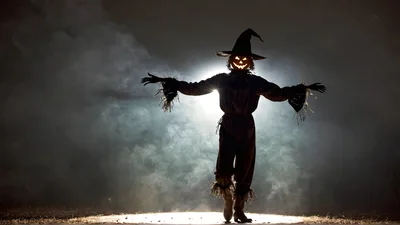 Scarecrow With Glowing Pumpkin Head In Foggy Night