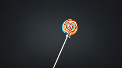 Colorful Swirl Lollipop Against Dark Background