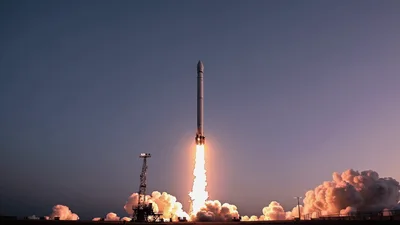 Space Rocket Launching Into The Sky At Sunset