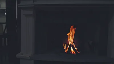 Cozy Fireplace Burning In A Dimly Lit Kitchen