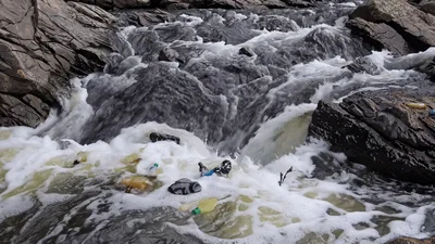 Plastic Waste Polluting A Rushing Mountain Stream