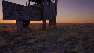 Old Wooden Truck Sculpture Standing In A Desert Sunset