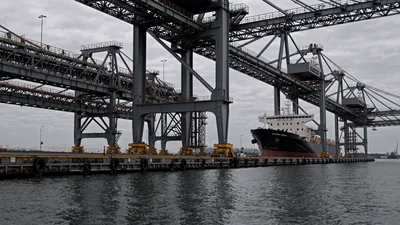Large Container Ship Docked At Industrial Port Terminal