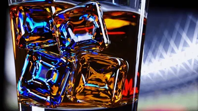 Glass Of Whiskey With Ice Cubes In A Bar