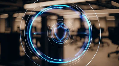 Digital Cybersecurity Shield Icon Over Office Background