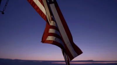 American Flag Waving Against A Twilight Sky