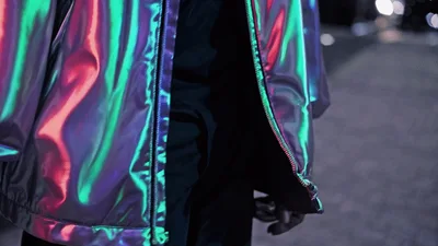 Person Wearing Iridescent Holographic Jacket Moving Hands