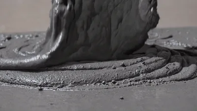 Thick Gray Concrete Pouring Onto A Flat Surface