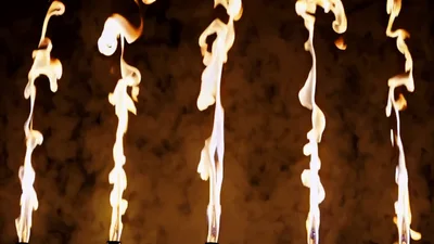Five Vertical Fire Jets Burning Against Dark Background