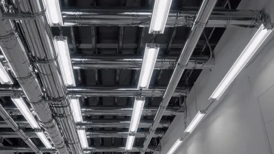 Industrial Ceiling With Chrome Pipes And Fluorescent Lights