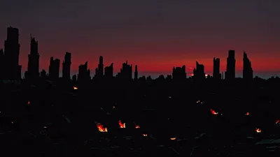 Ruined City Skyline Silhouette Under Dark Red Sunset