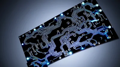 Glowing Blue Circuit Board Rotating Against Dark Background