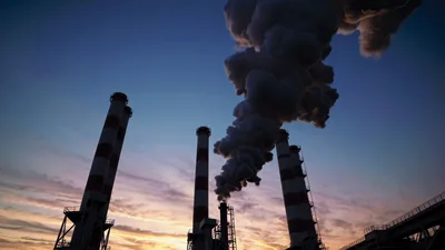 Industrial Power Plant Smokestacks Emitting Thick Smoke