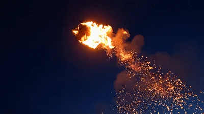 Flaming Pumpkin Launched From A Trebuchet At Night