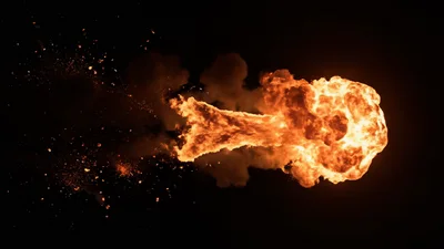 Large Fiery Explosion With Flying Debris On Black Background