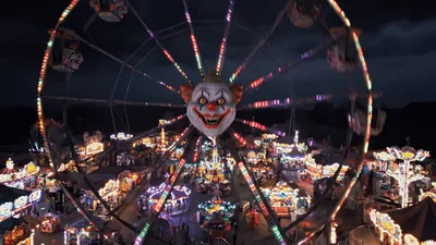 Ferris Wheel Spinning At A Night Carnival With Lightning