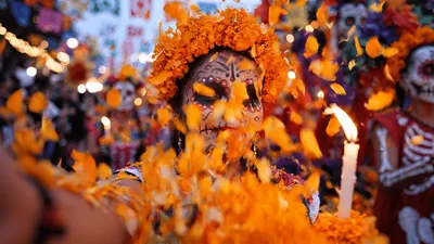 Woman With Day Of The Dead Makeup Throwing Marigold Petals