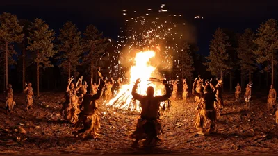 Native American People Performing Traditional Dance Around Bonfire