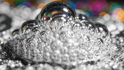 Silver Bubbles Rising From A Metallic Surface
