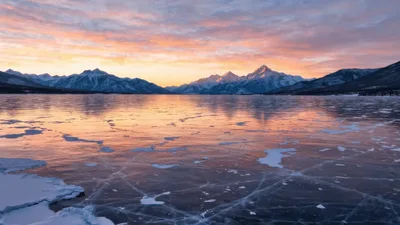 Frozen Lake Surface With Cracks Under Sunset Sky