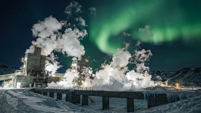 Geothermal Power Plant Under Vibrant Aurora Borealis Night Sky