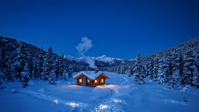 Cozy Log Cabin With Smoking Chimney In Snowy Forest