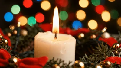 Burning White Christmas Candle With Festive Decorations