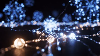 Glowing Blue And Warm White Fairy Lights On Dark Surface