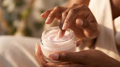 Close Up Of Woman Applying Face Cream