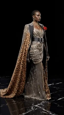 Model Walking In Leopard Print Cape And Sequin Gown