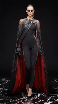Fashion Model Walking In A Black Cape And Bodysuit