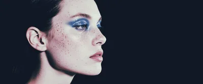 Portrait Of A Young Woman With Glittery Blue Eyeshadow