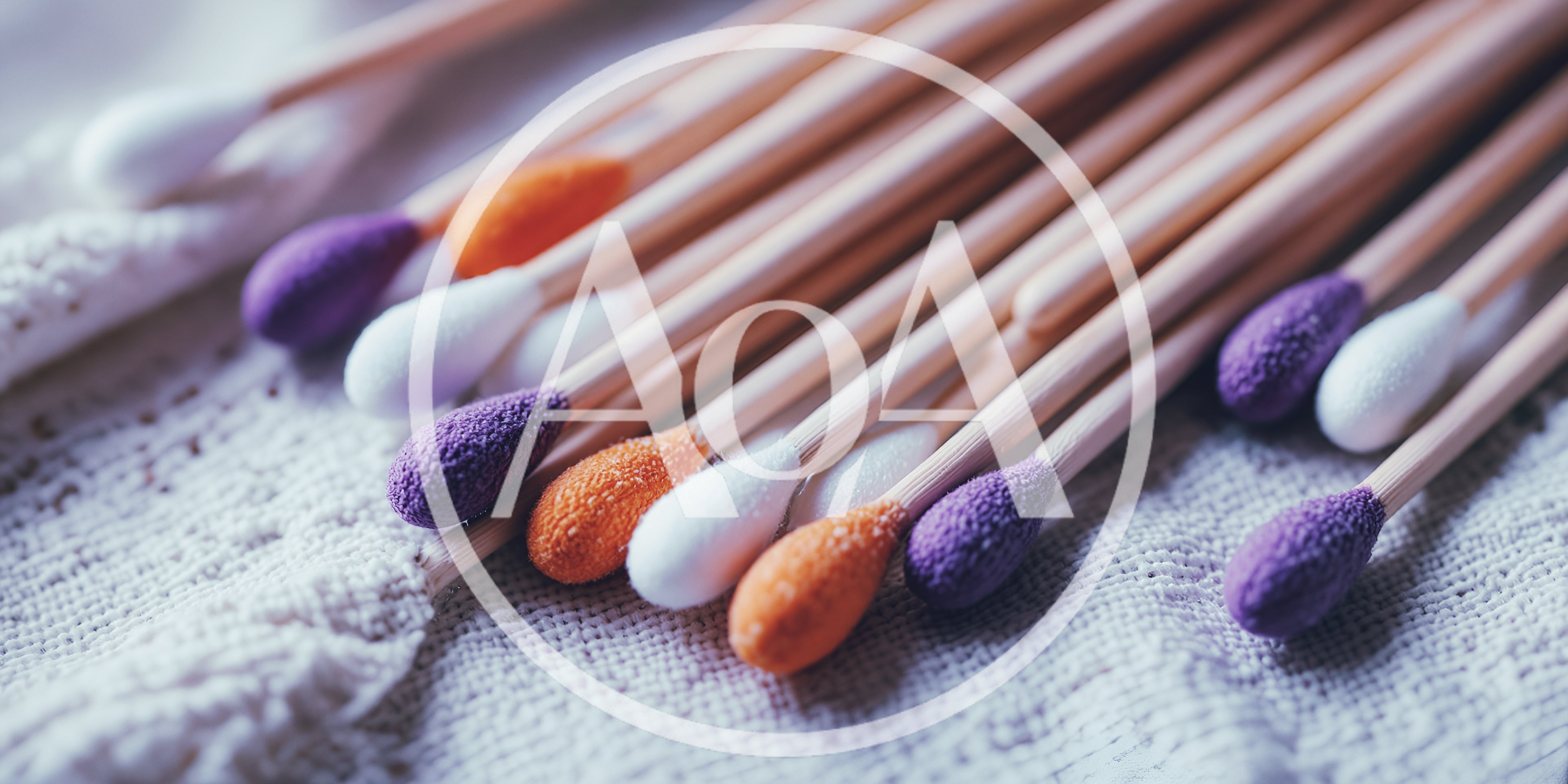 Colorful Cotton Swabs Arranged On Textured Fabric
